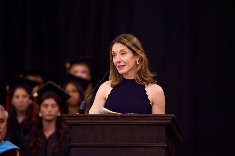 Dr. Emily Stern speaking at a podium